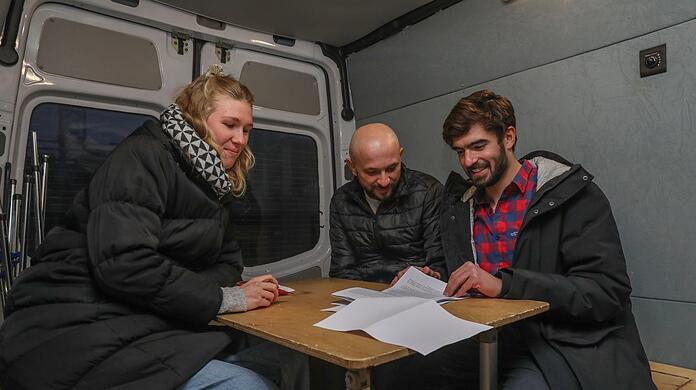 In ihrem Infobus beraten Anna Koch (26) und Omar Degner (27, rechts) Asylsuchende in München. Denn die Dokumente zu verstehen, ist oft nicht einfach.