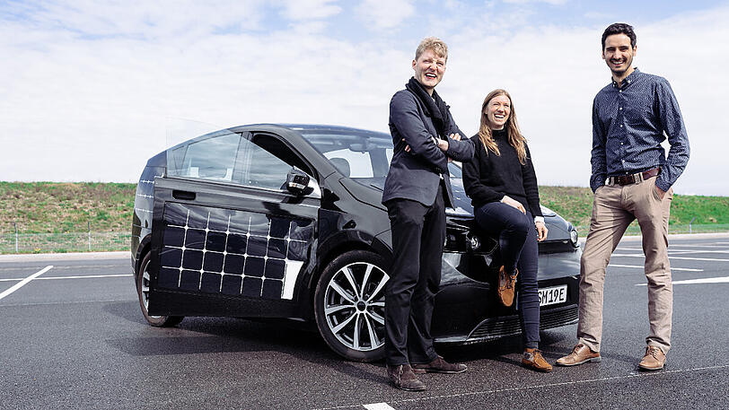 Die Gründer des Start-up-Unternehmens &bdquo;Sono Motors&ldquo; stehen vor dem &bdquo;Sion&ldquo;. Solarzellen sollen dessen Batterie nachladen.