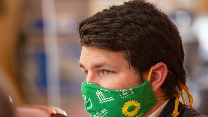 Johannes Becher (Grüne) trägt währenden der Sitzung des bayerischen Landtags einen Mundschutz. Foto: Peter Kneffel/dpa/Archivbild Johannes Becher (Grüne) trägt währenden der Sitzung des bayerischen Landtags einen Mundschutz. Foto: Peter Kneffel/dpa/Archivbild