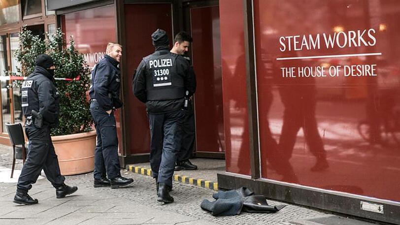 Polizeibeamte am Unglücksort: Nach einem Brand in den Räumen eines Sex- und Saunaclubs waren drei Männer vermutlich an Rauchvergiftungen gestorben.