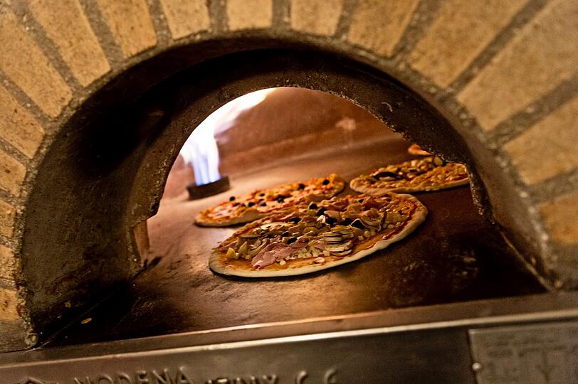 Pizza (Symbolfoto): Für Lieferdienste ist jede Fahrt ein Nervenkitzel. Bereits drei Pizza-Boten wurden überfallen und ausgeraubt.