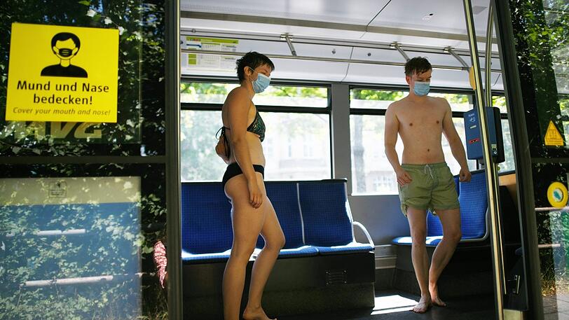 Vorbildlich mit Gesichtsmaske: Eisbachschwimmer in der Tram an der Tivolistraße.