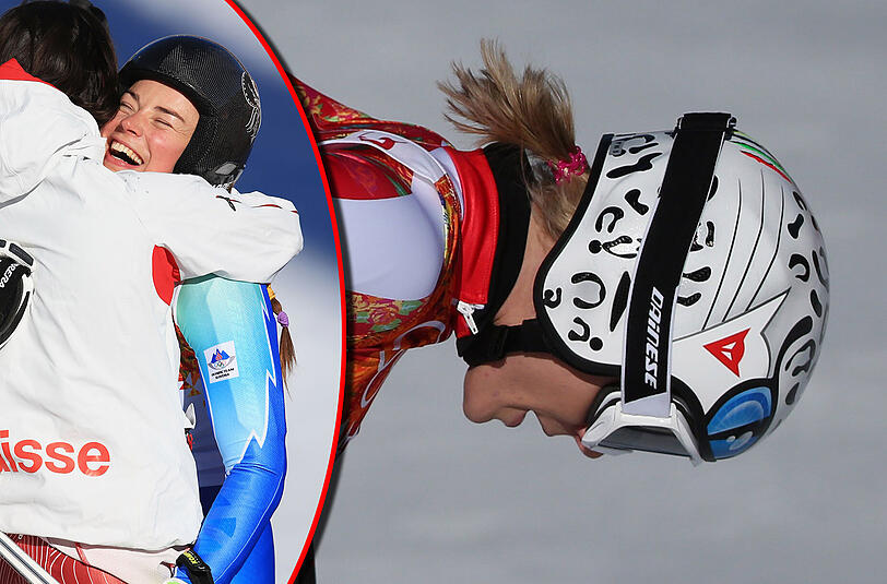 Enttäuscht schaut Maria Höfl-Riesch nach ihrem Lauf auf den Boden. Links umarmen sich Tina Maze und Dominique Gisin, die beide mit der gleichen Zeit Gold holten.