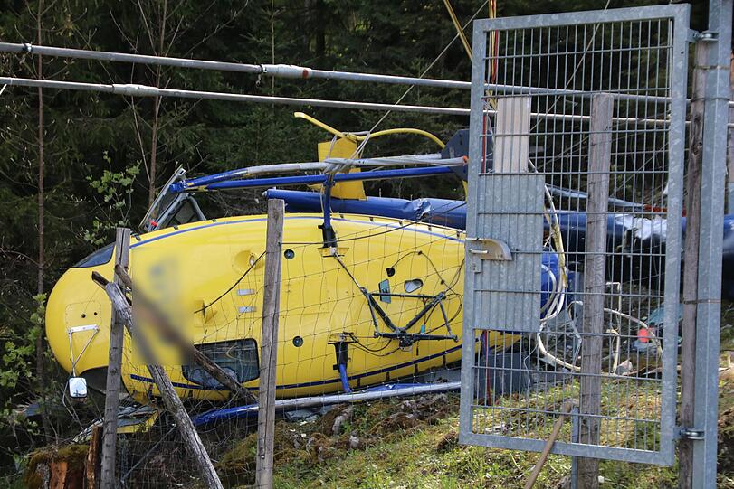 Ein zerstörter Hubschrauber liegt an einer Unfallstelle. Beim Absturz der Maschine wurde der Pilot verletzt.