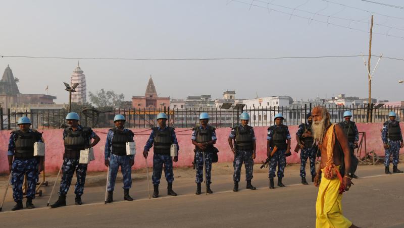 Ein Sadhu - ein hinduistischer Heiliger - geht in Ayodhya an Sicherheitsoffizieren vorbei. Der Streit zwischen Hindus und Muslimen um ein heiliges Areal hatte 1992 zu Ausschreitungen mit mehr als 2000 Toten geführt. Ein Sadhu - ein hinduistischer Heiliger - geht in Ayodhya an Sicherheitsoffizieren vorbei. Der Streit zwischen Hindus und Muslimen um ein heiliges Areal hatte 1992 zu Ausschreitungen mit mehr als 2000 Toten geführt.