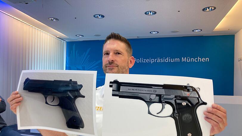 Polizeisprecher Thomas Schelshorn zeigt Fotos der Softair-Waffe und der echten Waffe. (Archivbild)