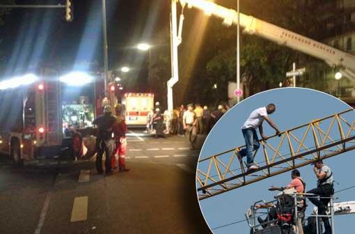 Ein Mann auf einem Kran hält die Münchner Einsatzkräfte in Atem. Die Bilder
