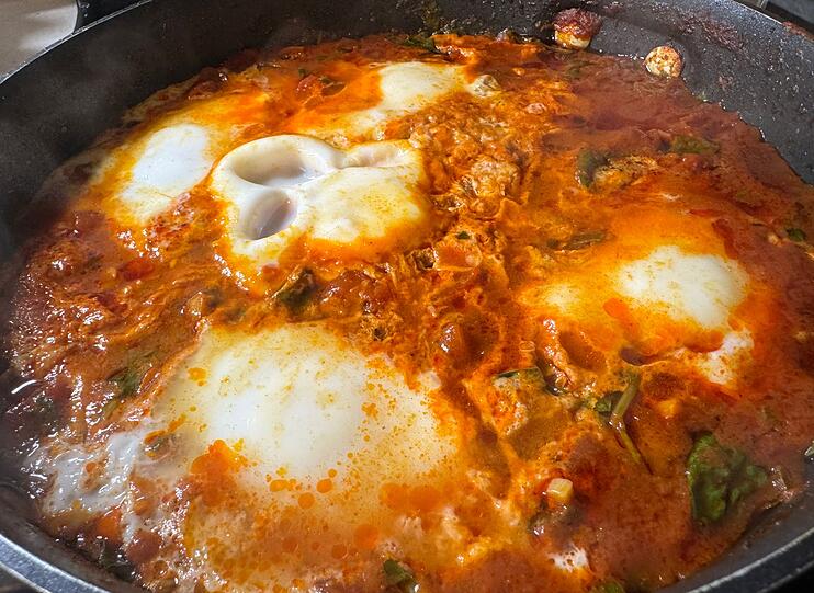Dann den Deckel auf die Pfanne und das Shakshuka zehn Minuten k&ouml;cheln lassen, bis die Eier gestockt sind. Zum Schluss zerbr&ouml;seln Sie etwas Feta und streuen Petersilie dar&uuml;ber. Als Beilage passen griechischer Joghurt, Kichererbsen-Hummus oder eine Scheibe Vollkornbrot.