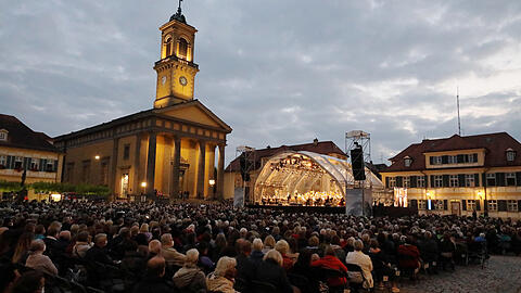 Trotz düsterer Wolken trocken: Der Karlsplatz in Ansbach mit der klassizistischen Ludwigskirche beim Konzert "Oper für alle" mit dem Bayerischen Staatsorchester.