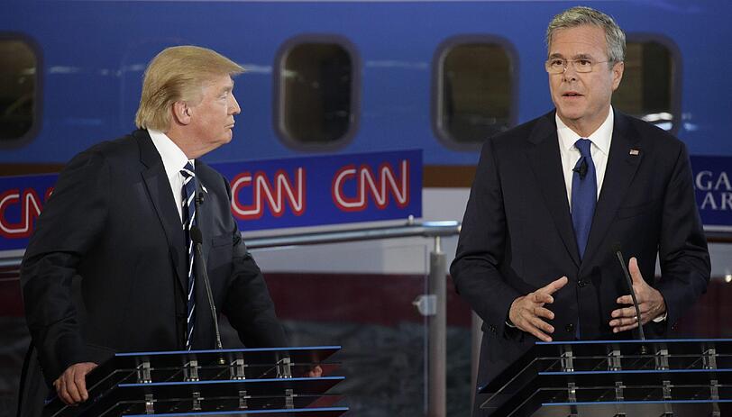 Donald Trump hört seinem Konkurrenten Jeb Bush bei der TV-Debatte genau zu.