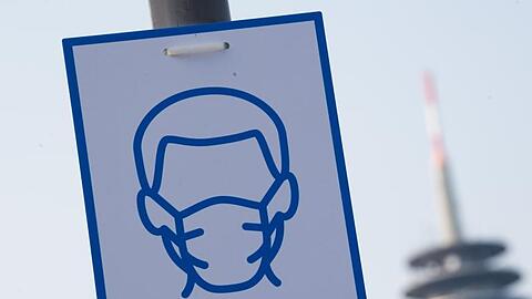 Ein Piktogramm mahnt in Düsseldorf das Einhalten der Maskenpflicht an.