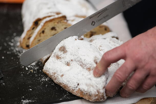 Ein Stollen wird aufgeschnitten. So wird er typischerweise serviert. Ein Stollen wird aufgeschnitten. So wird er typischerweise serviert.