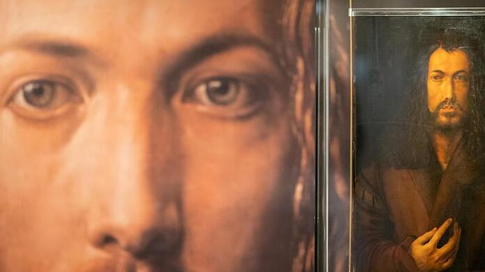 Eine Reproduktion des Gemäldes "Selbstbildnis im Pelzrock", die den Maler Albrecht Dürer darstellt.