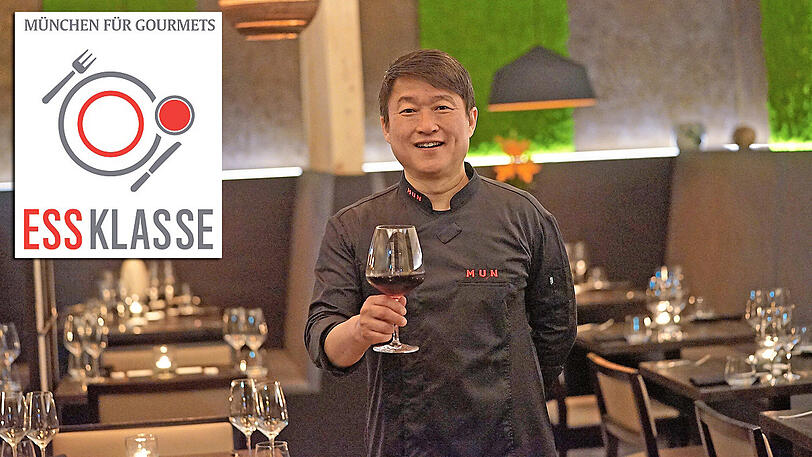 Gastgeber Mun Kim mit einem Glas Rotwein in seinem Restaurant "MUN" in Haidhausen.