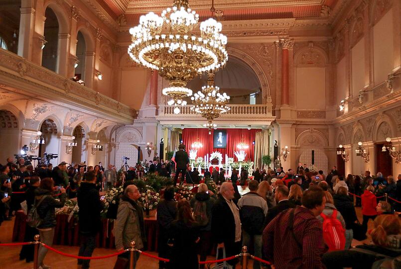 Der Sarg mit dem Leichnam des Sängers Karel Gott ist im Prager Sophienpalais aufgebahrt, davor stehen Menschen, um Abschied zu nehmen.