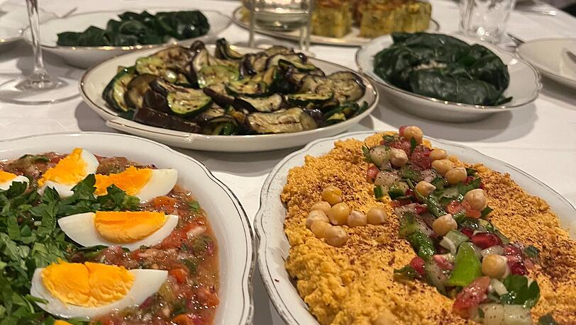 Die Gerichte werden auf die lange Tafel gestellt, jeder kann davon probieren.