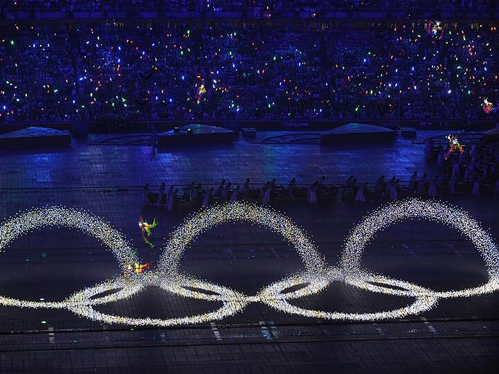 Fliegende Tänzer ziehen die Olympischen Ringe in die Luft: Die Spiele können beginnen.