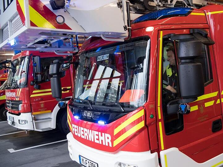 Feuerwehrmänner der Berufsfeuerwehr München fahren zu einem Einsatz. Foto: Sven Hoppe