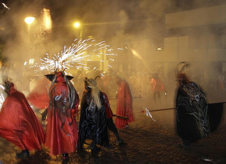 Männer, die als Dämonen verkleidet durch die Straßen von Alangasi, Ecuador, geistern. Am Karsamstag werden die Dämonen in die Kirchen getrieben und symbolisch eingesperrt und von den Christen getötet.
