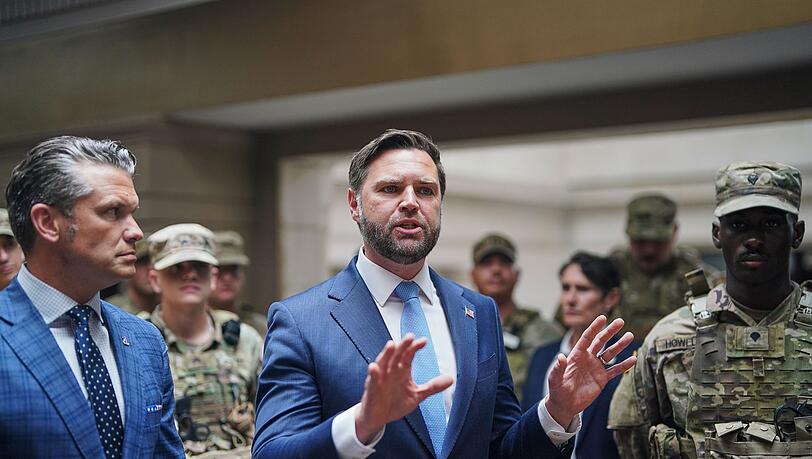 Verteidigungsminister Hegseth (l) und Vizepräsident Vance sprechen im Hauptbahnhof von Washington mit Mitgliedern der Nationalgarde.