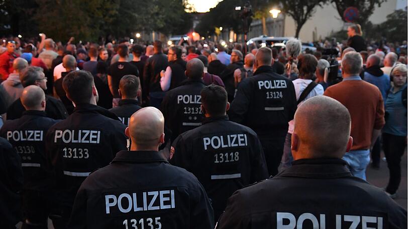 Sachsen-Anhalt, Köthen: Menschen haben sich in Begleitung von Polizisten in der Innenstadt versammelt, nachdem dort ein 22-Jähriger bei einem Streit zwischen zwei Männergruppen ums Leben gekommen war.