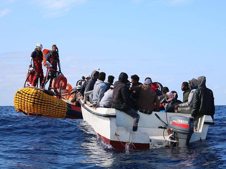 Teammitglieder der "Ocean Viking" nähern sich einem Boot in Seenot in den Gewässern vor Libyen.
