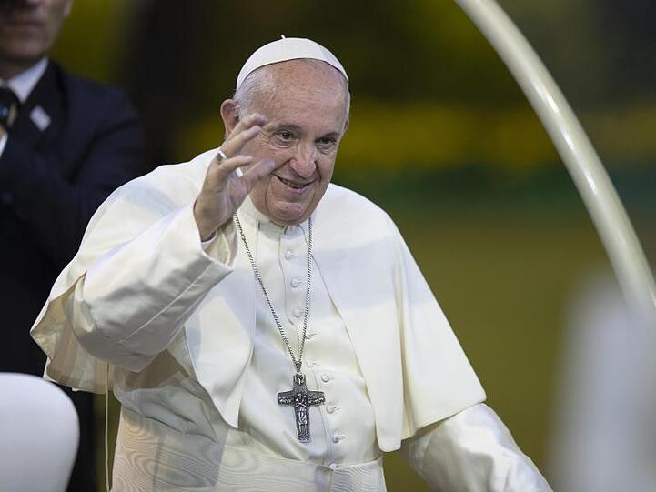 Papst Franziskus begrüßt Gläubige bei seiner Ankunft zur Messe im Nationalstadion.