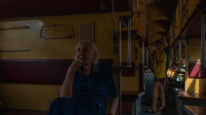 Die 91-jährige Binnenvertriebene Iraida Worobiowa sitzt am Bahnhof von Pokrowsk in einem Zug nach Dnipro.