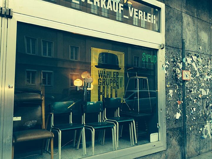 Darunter sind Geschäfte wie dieses, hier mit Wahlplakat...