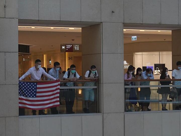 Demonstranten in einem Hongkonger Einkaufszentrum zeigen eine US-Flagge.