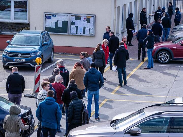 Hier ist Geduld gefragt: Apotheker und Mitarbeiter von Versorgungsbetrieben stehen auf dem Gelände des Zuckerwerks in Anklam in einer langen Schlange am Verkaufsbüro an.