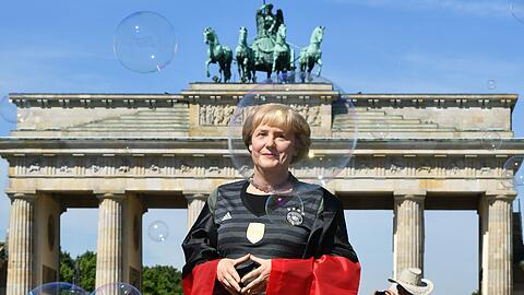 Angela Merkel im Deutschlandtrikot vor dem Brandenburger Tor - leider nur als Wachsfigur. Die Bilder!