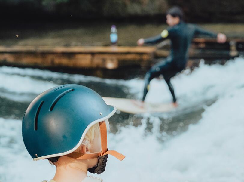 Noch auf dem Rad, bald auf der Welle? Vor allem Kinder schauen am Eisbach wieder gebannt den Surfern zu, wenn auch nur ein Teil der Welle surfbar ist.