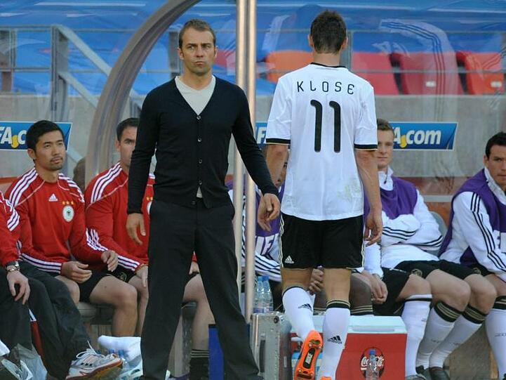 Der damalige deutsche Spieler Miroslav Klose (r) geht zum damaligen Assistenztrainer von Deutschland, Hansi Flick. Foto: Bernd Weissbrod/dpa/Archivbild