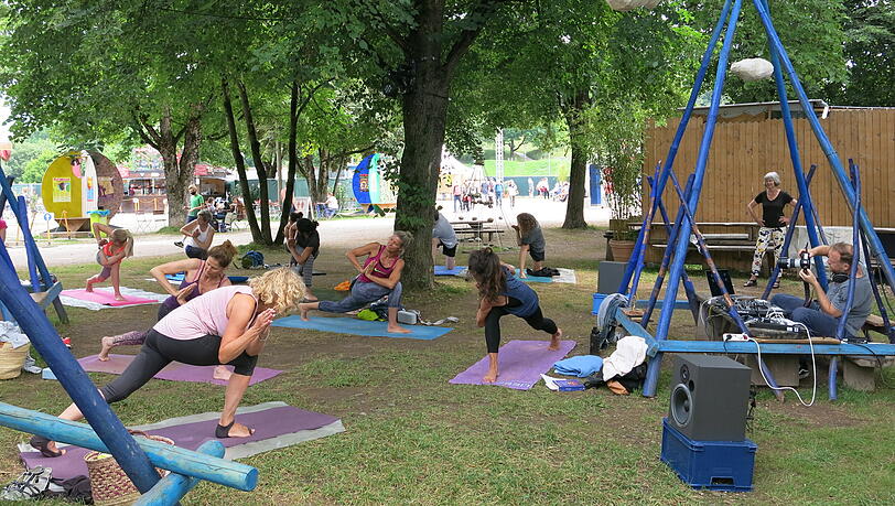 "Wisdom, Beats & Poses": Das ist Yoga mit lässiger Musik-Begleitung im "Garten der fliegenden Wolken" auf dem Tollwood-Gelände.