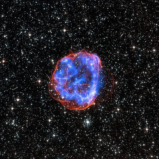 Die  Staubwolke SNR 0519-69.0. Dabei handelt es sich um eine heiße, sich ausbreitende Wolke mit den Überresten einer Sternexplosion.
