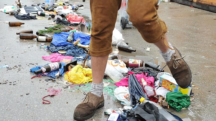 Müll auf dem Wiesn-Gelände: ein ganz normales Bild auf dem Oktoberfest, auch, weil es kaum Abfallbehälter gibt. Das hat einen ganz bestimmten historischen Grund.