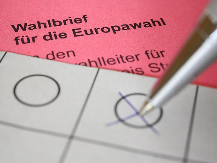 Eine Frau kreuzt einen Wahlzettel für die Briefwahl zum europäischen Parlament an. Foto: Sebastian Gollnow/Archivbild