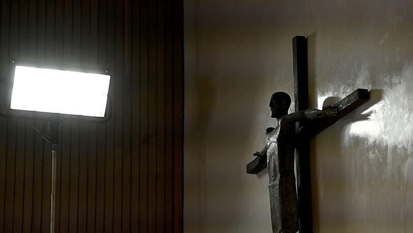Ein Kreuz hängt an der Wand.
