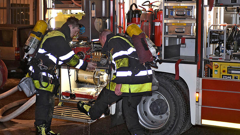 Zwei Feuerwehrmänner reinigen ihre Stiefel nach dem Einsatz in der stark verrauchten Wohnung. Zwei Feuerwehrmänner reinigen ihre Stiefel nach dem Einsatz in der stark verrauchten Wohnung.