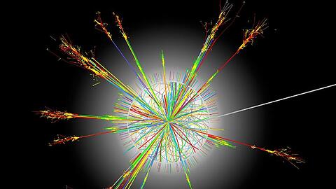 Die Illustration zeigt die Kollision von Atomkernen, Tausende von neuerzeugten Teilchen fliegen dabei in alle Richtungen.