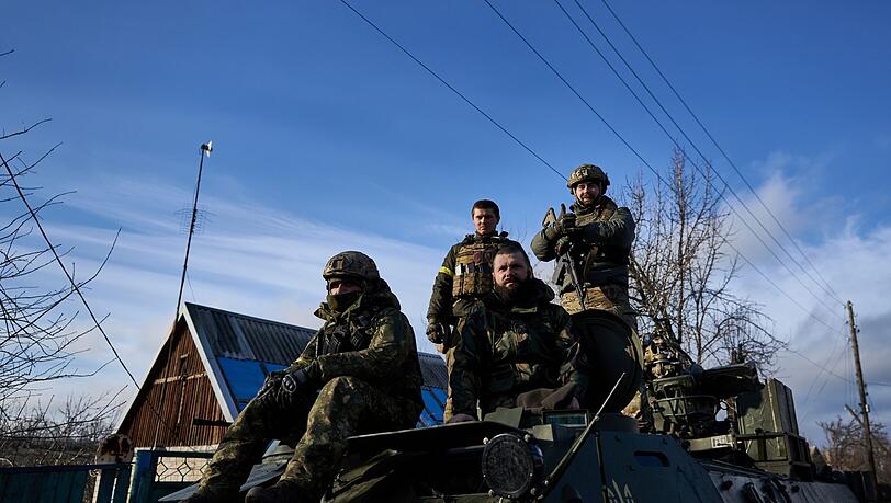 Ukrainische Soldaten fahren durch Bachmut.