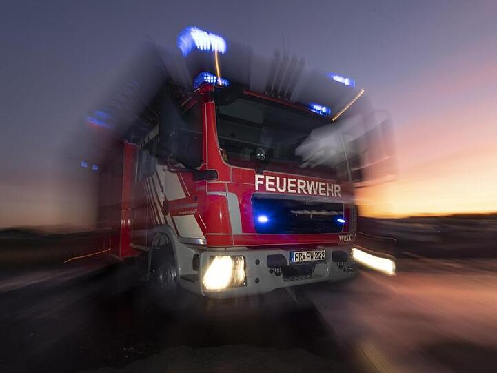 Ein Feuerwehrfahrzeug mit eingeschaltetem Blaulicht. Foto: Patrick Seeger/dpa/Symbolbild
