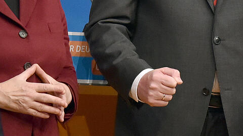 Raute und Faust: Die Hände von Bundeskanzlerin Merkel und Bayerns Ministerpräsidenten Seehofer. Foto: Uwe Anspach/Archiv