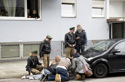 Die Polizei kümmert sich um die Tante und Cousine des Täters, die am Tatort zusammenbrechen.