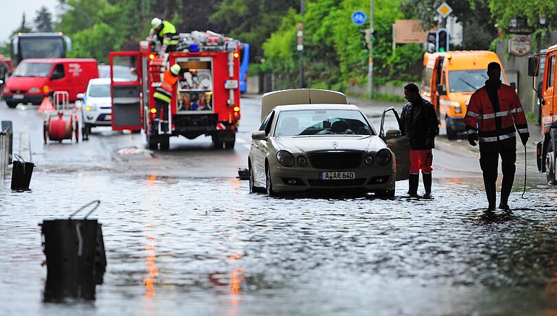 Ein Auto steht am Donnerstag in München in einer S-Bahn-Unterführung im Wasser und muss von der Feuerwehr geborgen werden.