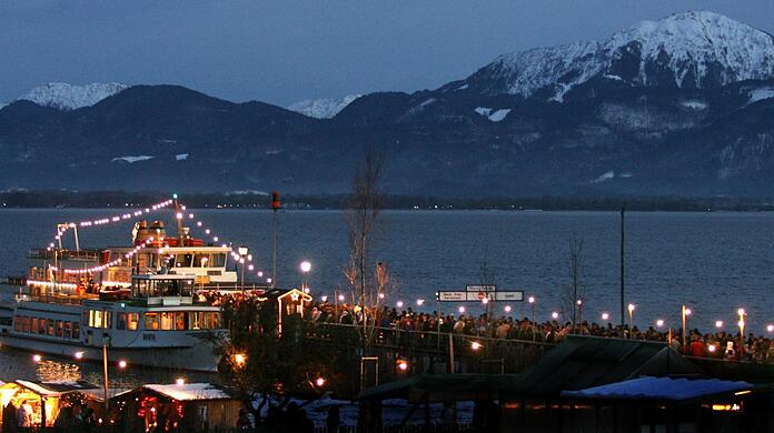 Ausflügler kommen am Bootssteg auf der Fraueninsel im Chiemsee an.
