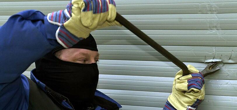 Ein Einbrecher mit einem Stemmeisen (gestelltes Bild).