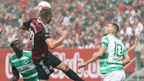 Der Nürnberger Florian Hübner (M) kämpft mit den Fürthern Ragnar Ache (l) und Branimir Hrgota um den Ball.