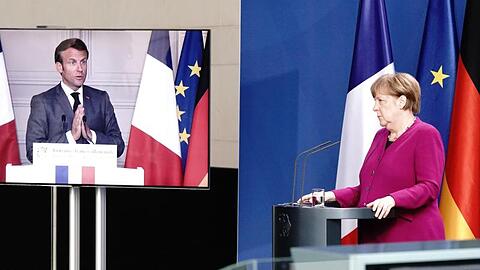 Bundeskanzlerin Merkel und Emmanuel Macron bei einer Pressekonferenz. Frankreichs Präsident ist per Video zugeschaltet.